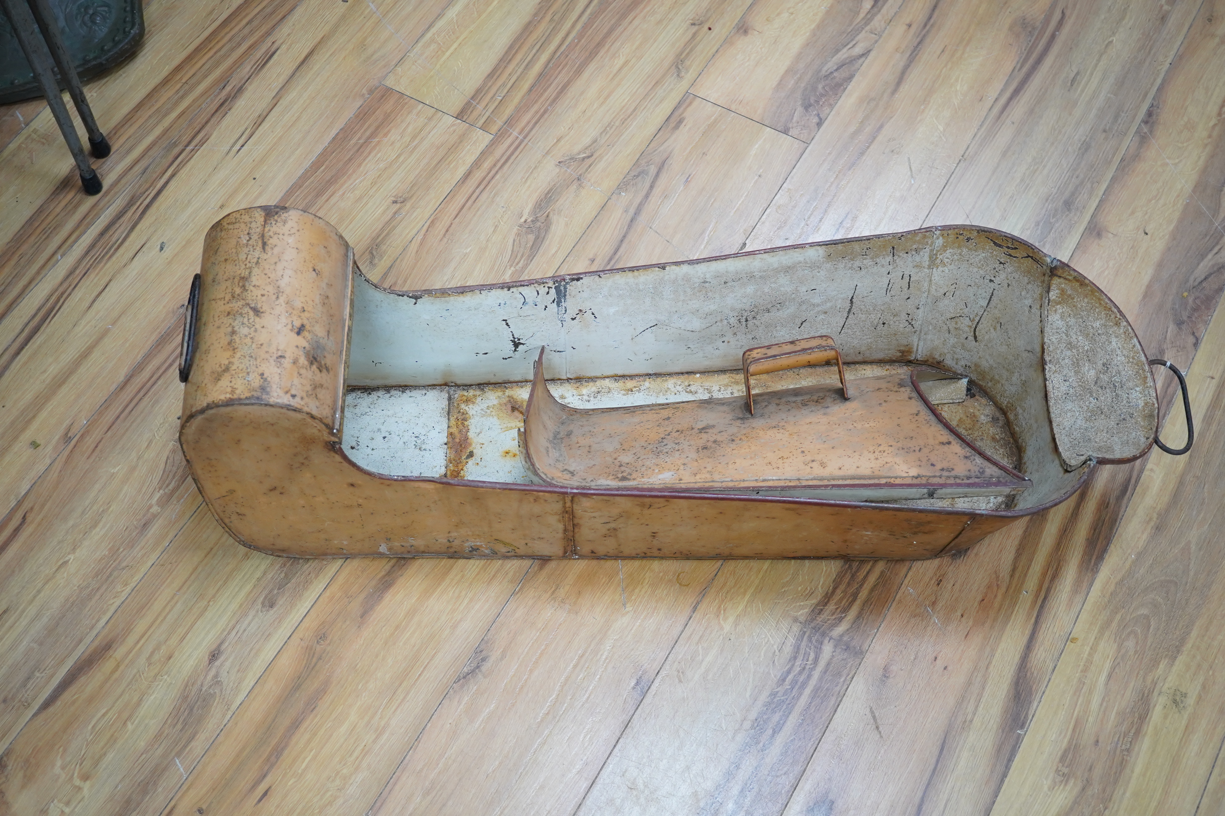 A WWII tin leg bath, with cover and tap to foot end, length 88cm. Condition - poor to fair, surface rust overall.